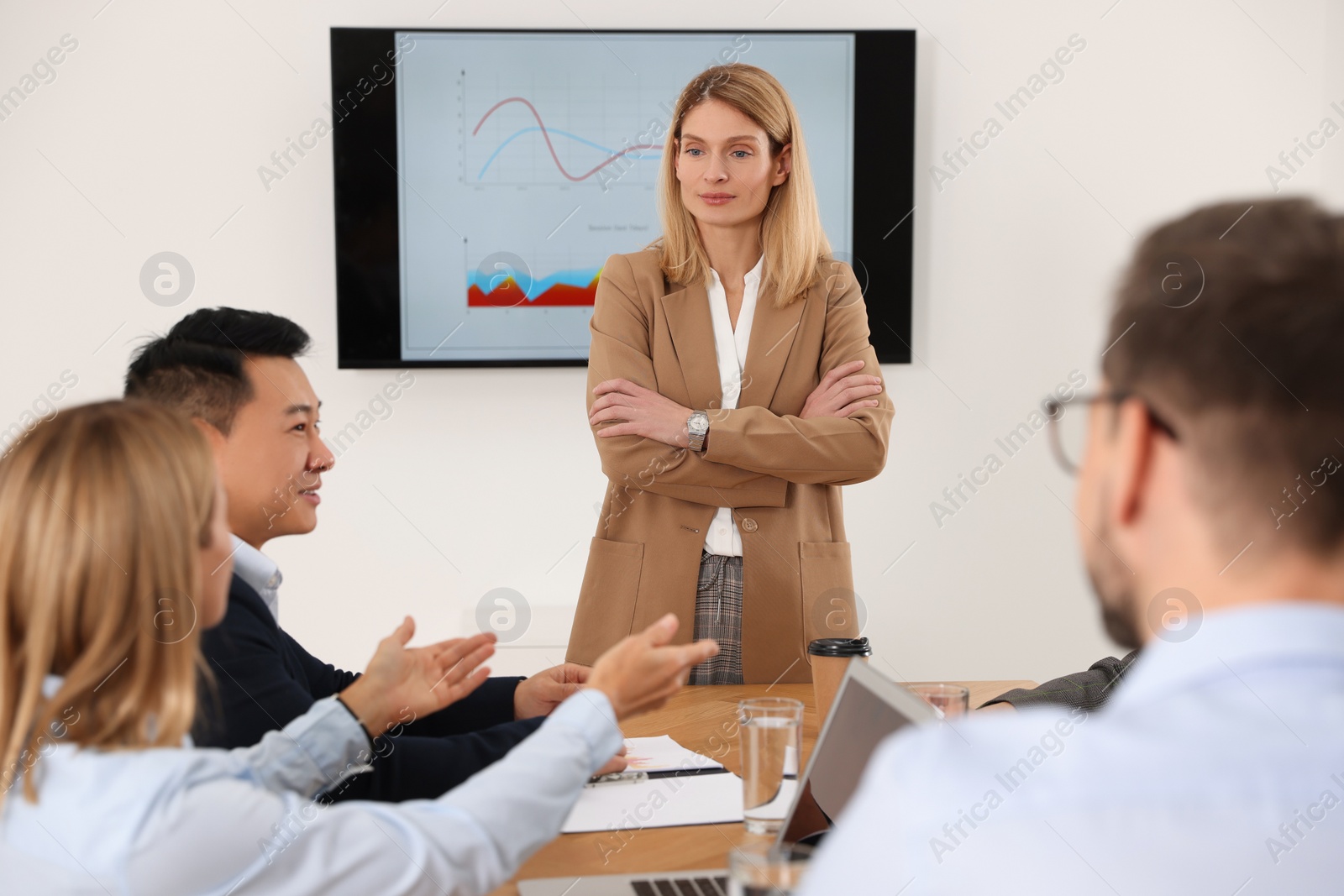 Photo of Businesswoman having meeting with her employees in office