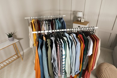 Photo of Racks with stylish clothes indoors, above view. Fast fashion