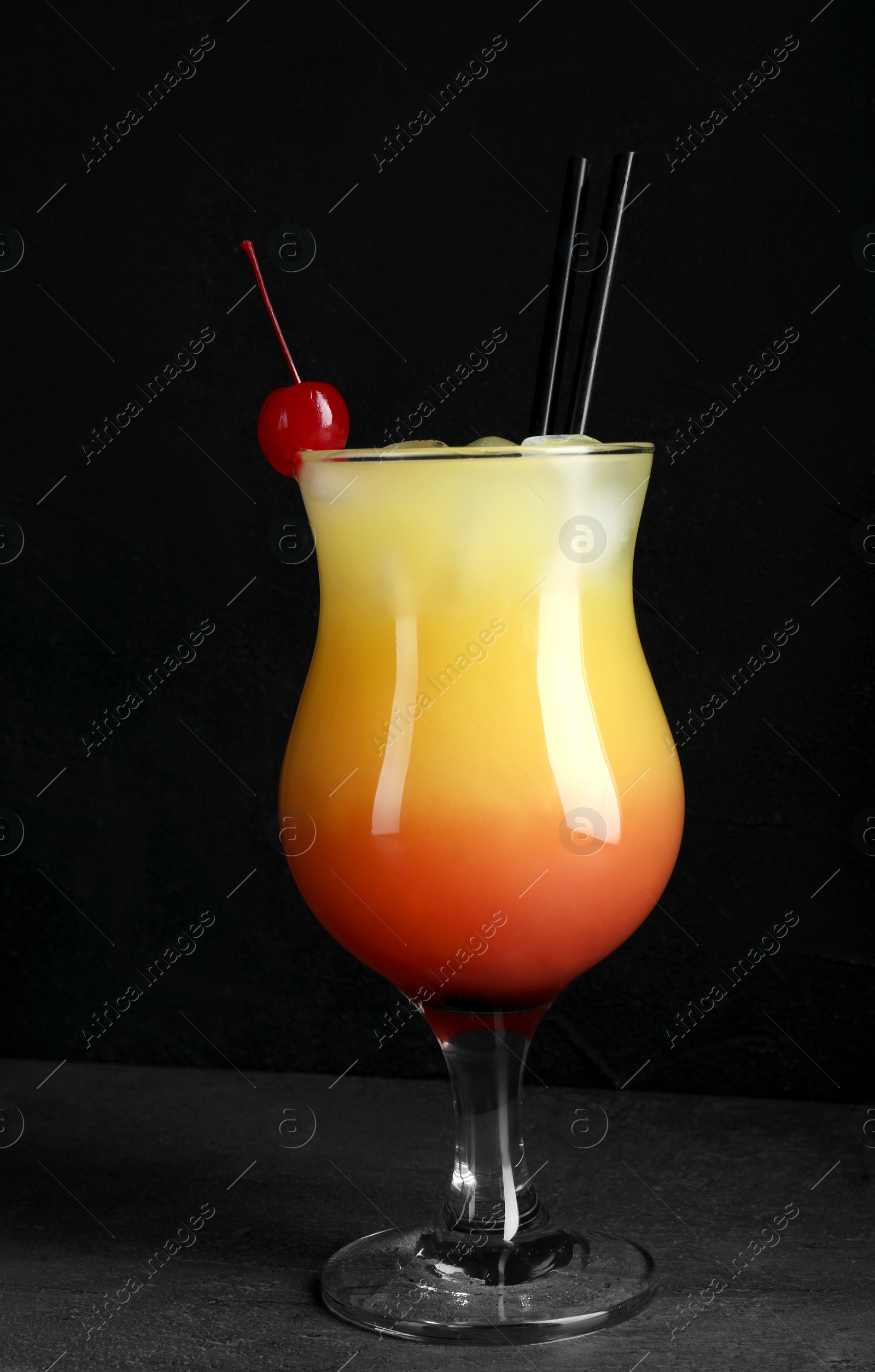 Photo of Just made appetizing cocktail Sex on the Beach, black background