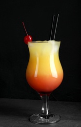 Photo of Just made appetizing cocktail Sex on the Beach, black background