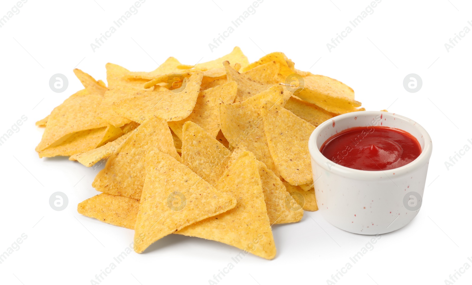 Photo of Tasty tortilla chips with ketchup on white background