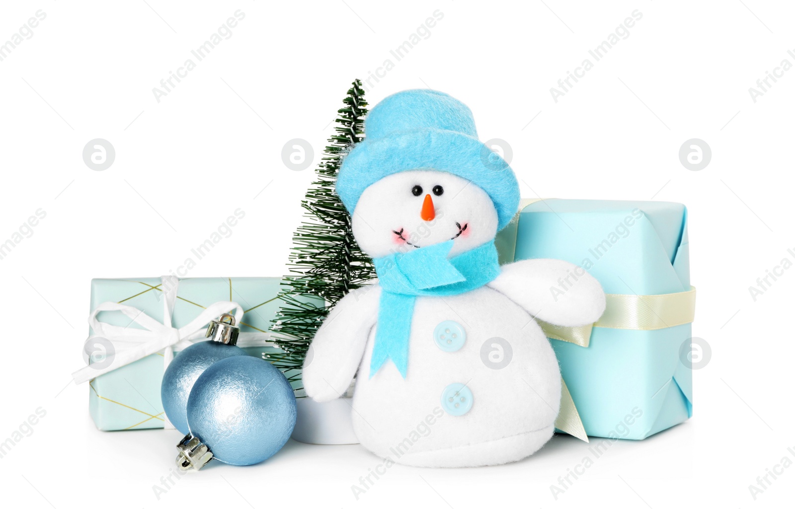 Photo of Cute snowman toy, Christmas tree and decor on white background