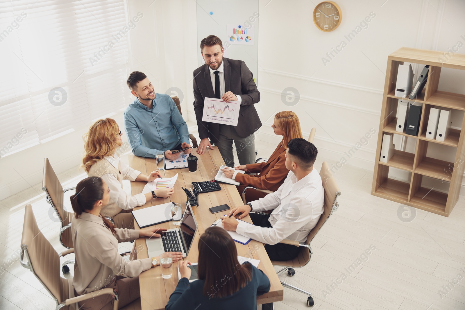 Photo of Businesspeople having meeting in office. Management consulting