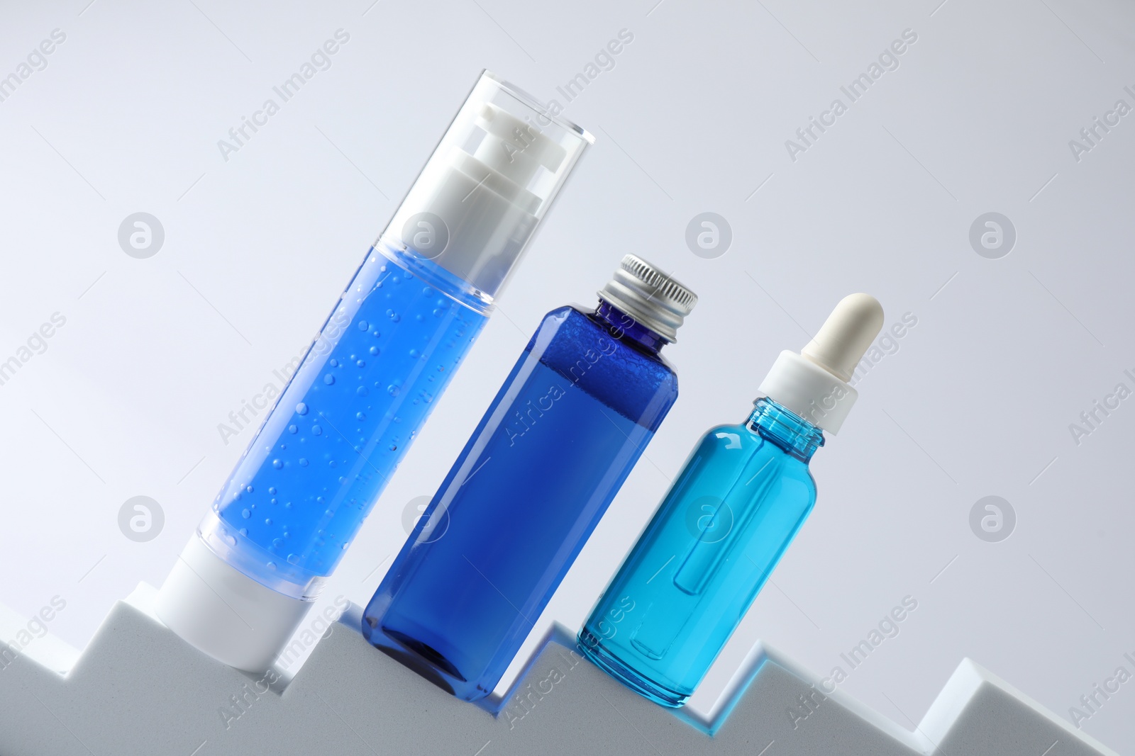 Photo of Set of luxury cosmetic products on stairs against white background