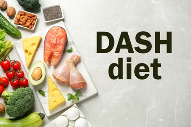 Dietary approaches to stop hypertension. Many different healthy food and words Dash diet on light marble table, flat lay