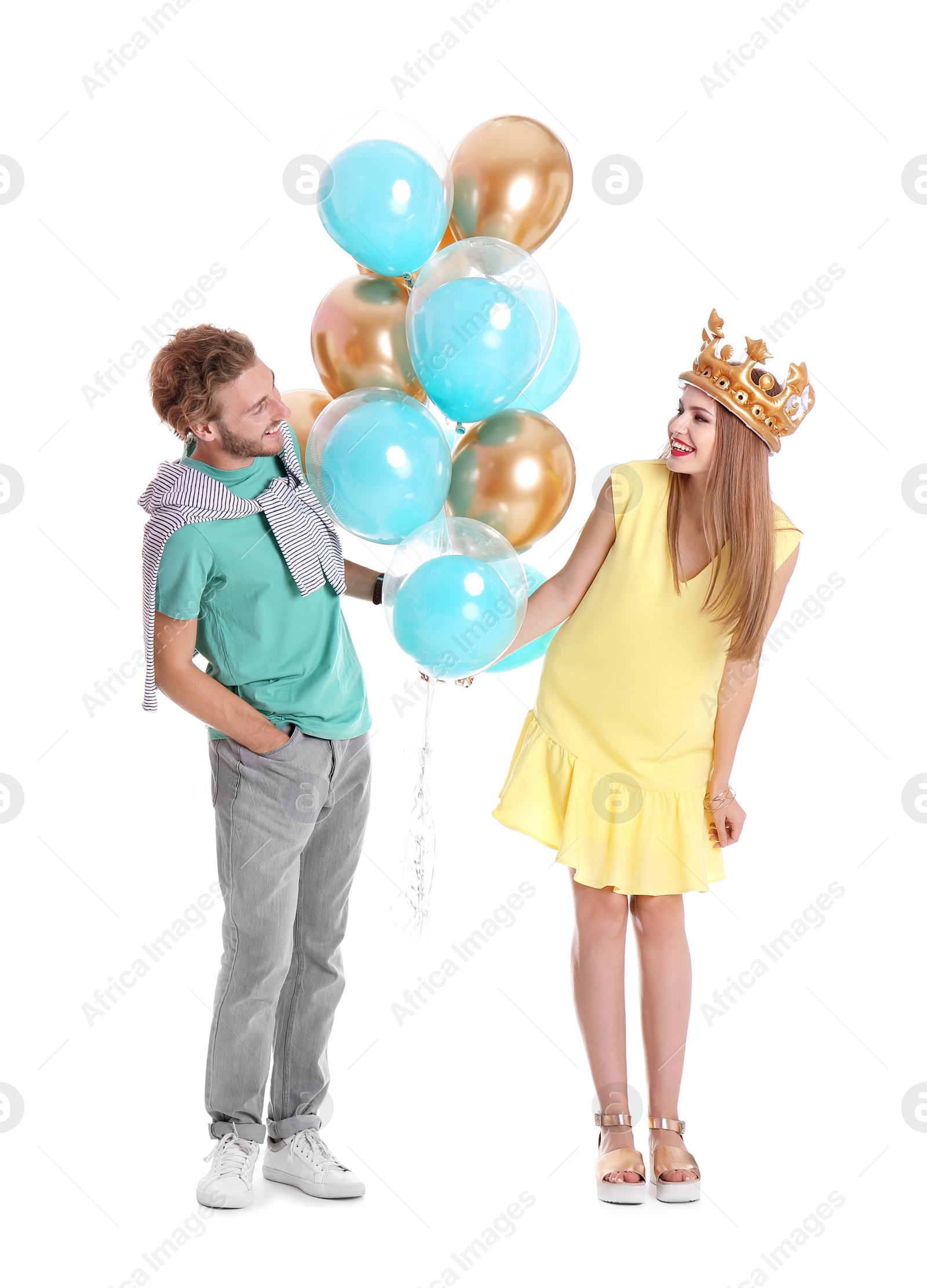 Photo of Young couple with air balloons on white background