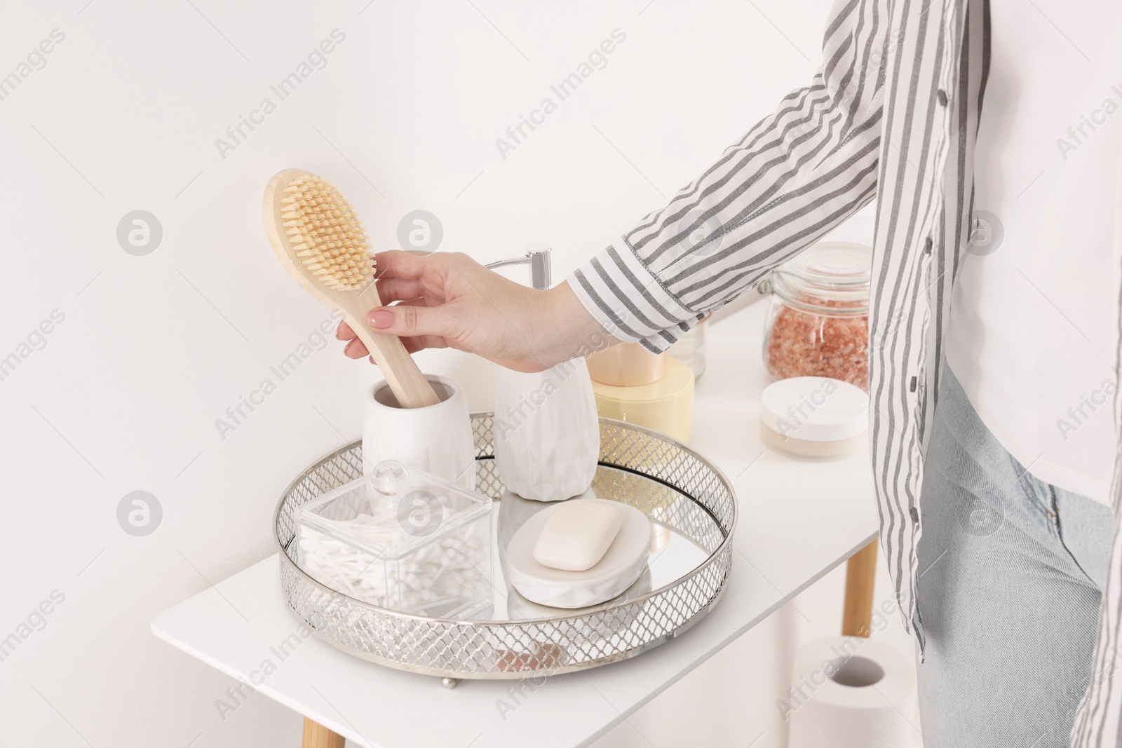 Photo of Bath accessories. Woman with brush indoors, closeup