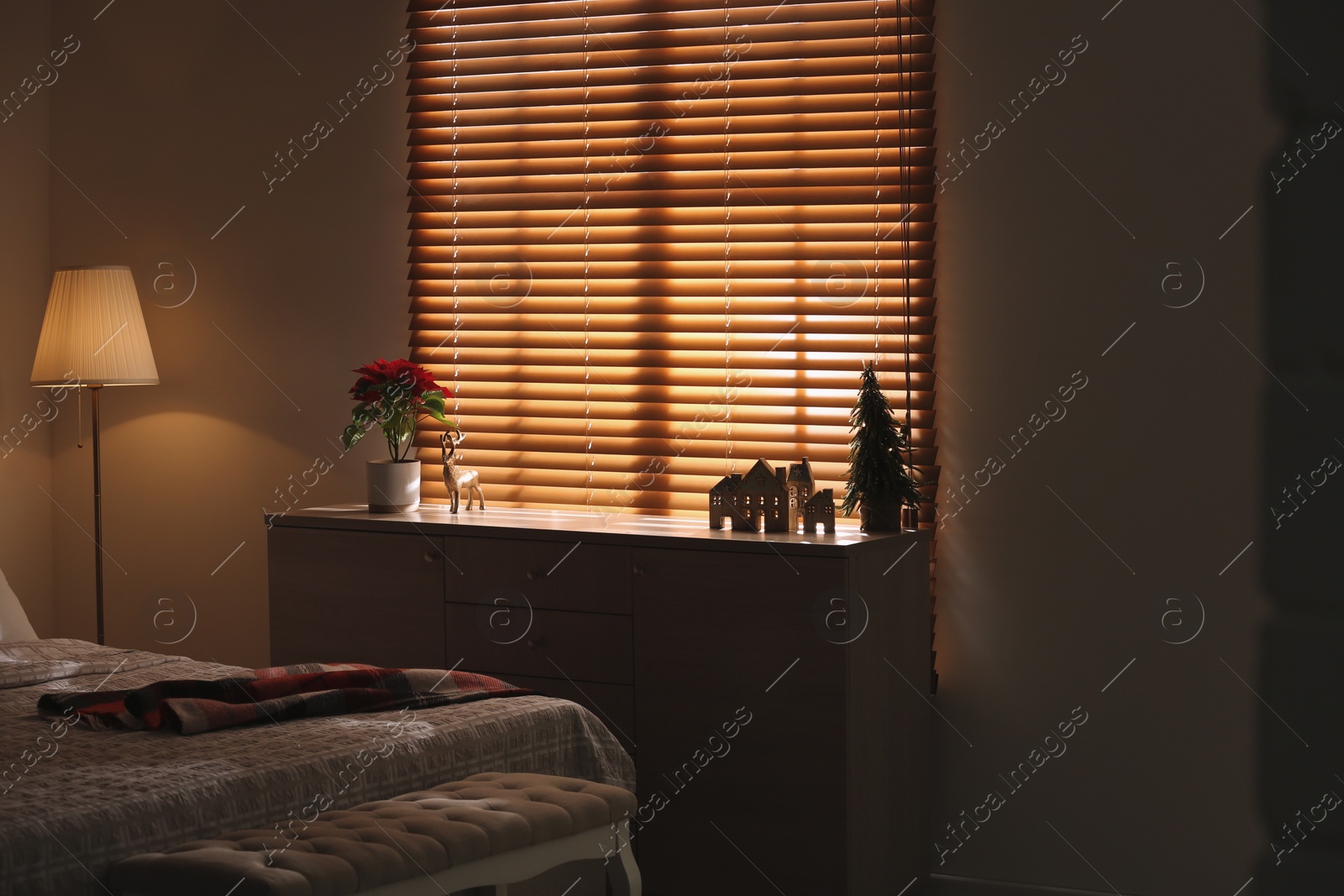 Photo of Cozy bedroom with different Christmas decorations. Interior design