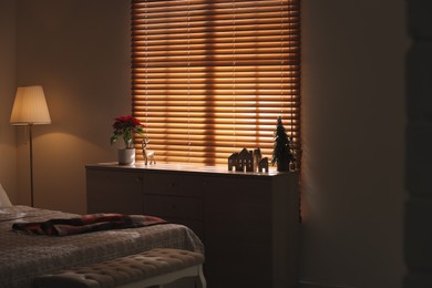 Photo of Cozy bedroom with different Christmas decorations. Interior design