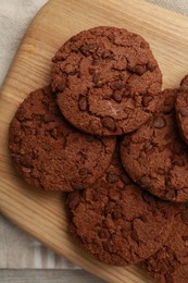 Delicious chocolate chip cookies on table, top view