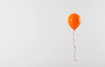 Photo of Bright balloon on light background, space for text. Celebration time