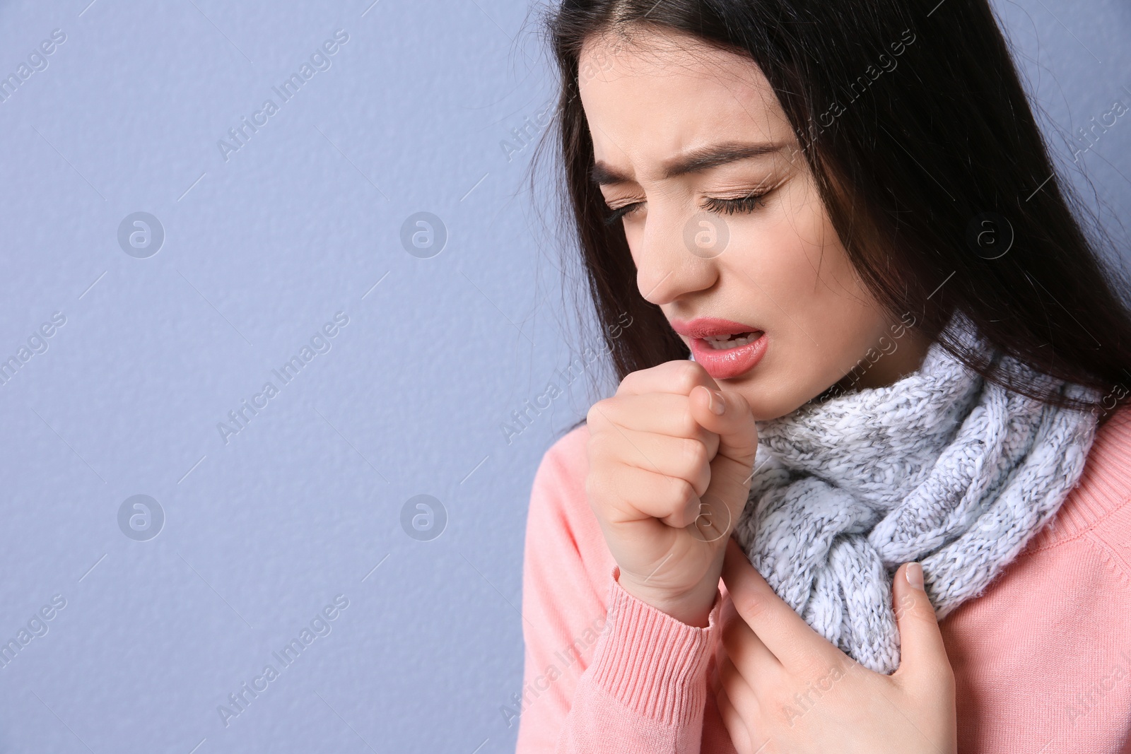 Photo of Young woman coughing on color background