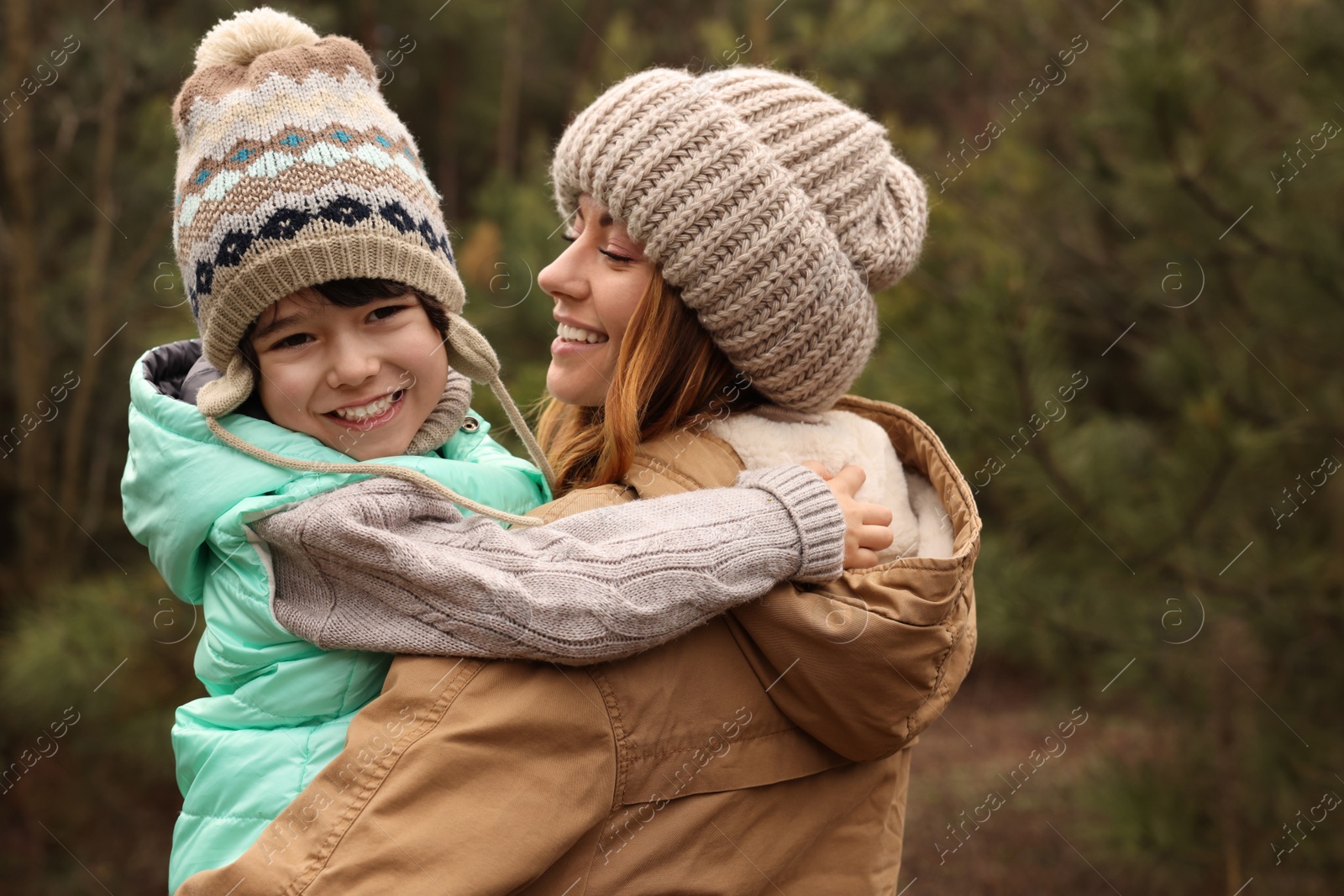 Photo of Woman and her son spending time together in forest