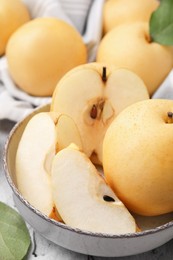 Photo of Delicious apple pears on white textured table, closeup