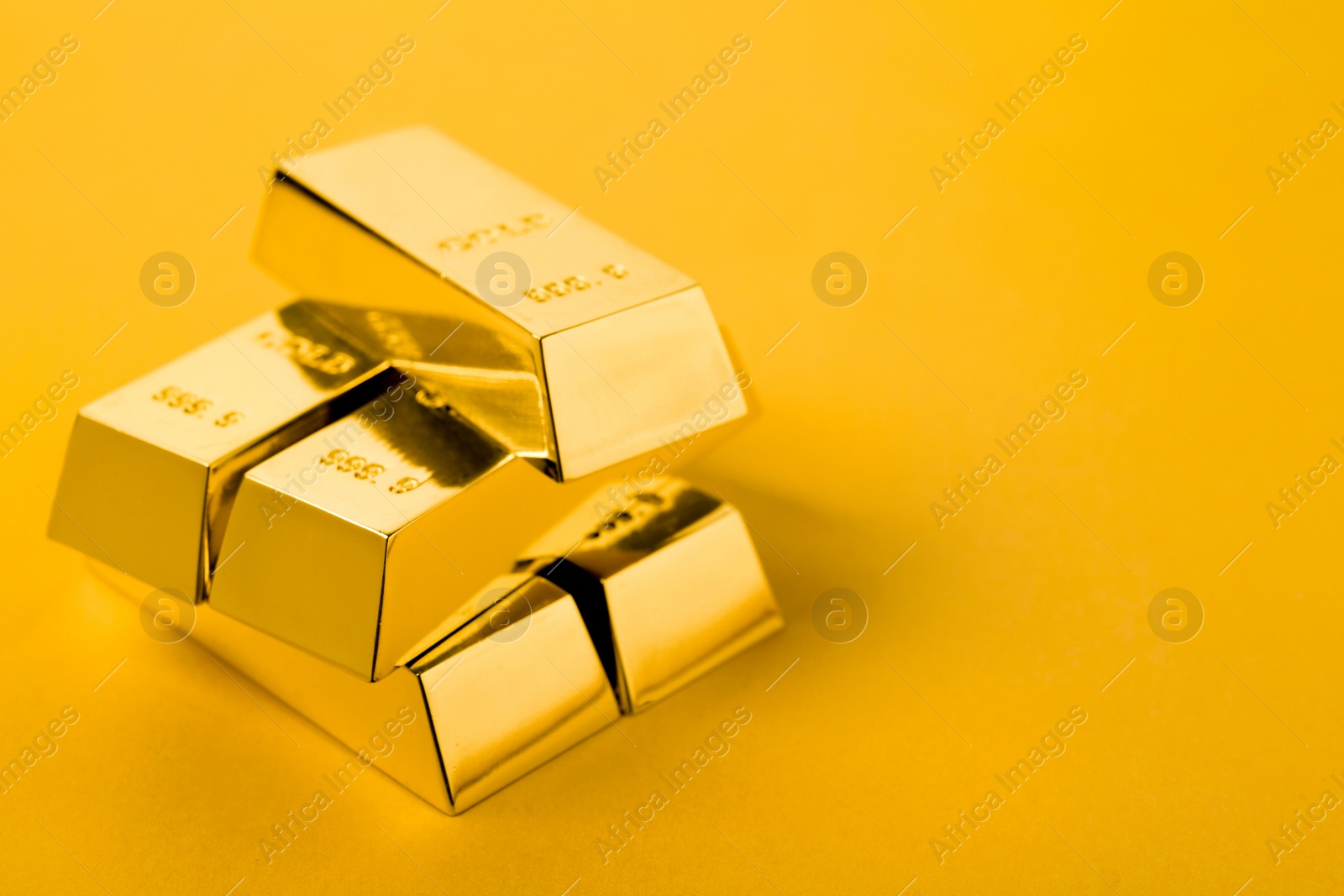 Photo of Precious shiny gold bars on color background. Space for text