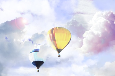 Image of Fantastic dreams. Hot air balloons in sky with fluffy clouds 