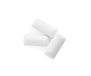 Photo of Three pieces of chewing gum on white background, top view