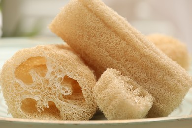 Photo of Loofah sponges on table indoors, closeup. Personal hygiene products