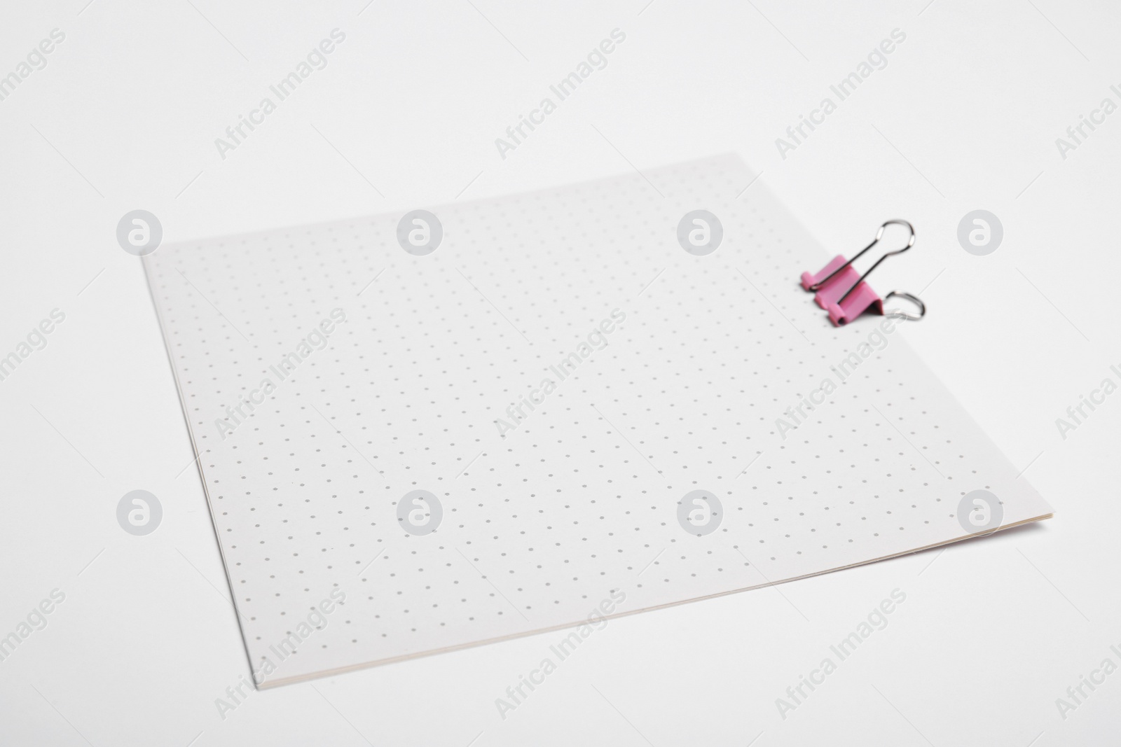 Photo of Sheets of paper with clip on white background