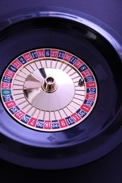 Photo of Roulette wheel with ball, above view. Casino game