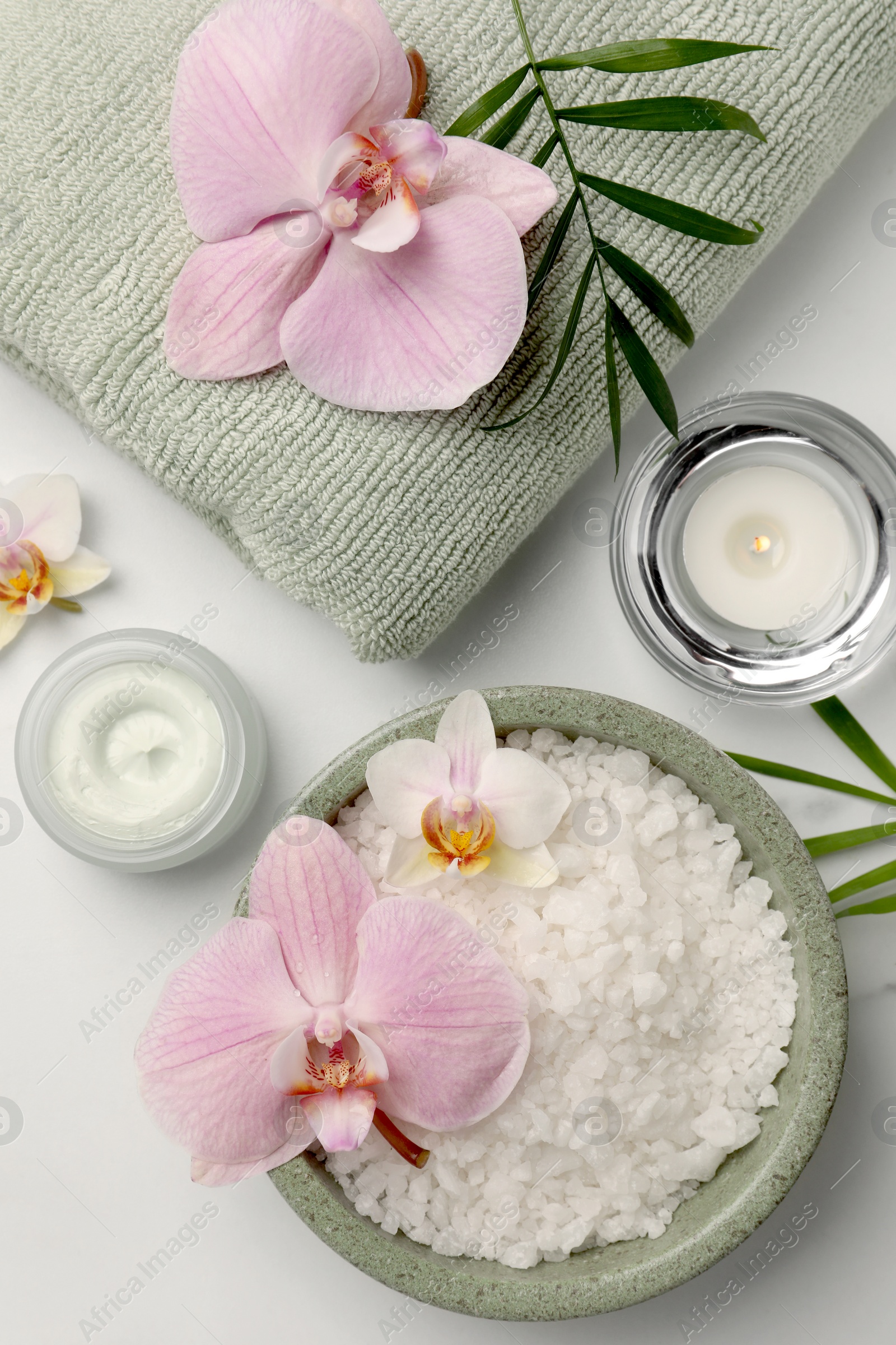 Photo of Flat lay composition with different spa products and flowers on white marble table