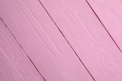 Texture of pink wooden surface as background, closeup