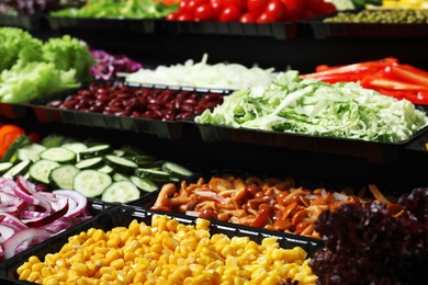 Photo of Salad bar with different fresh ingredients as background