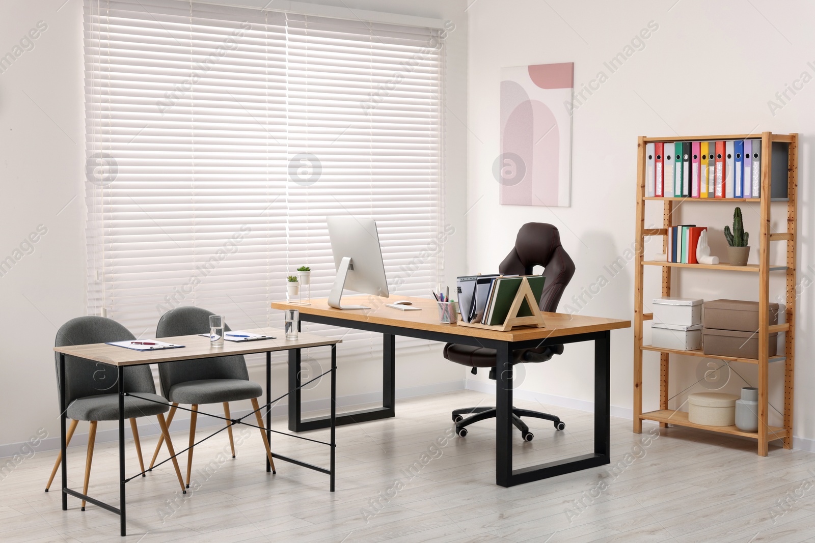 Photo of Director's office with large wooden table and comfortable armchairs. Interior design