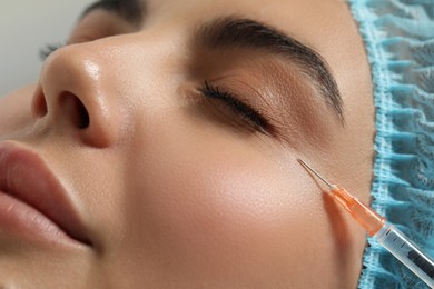 Young woman getting facial injection in clinic, closeup. Cosmetic surgery