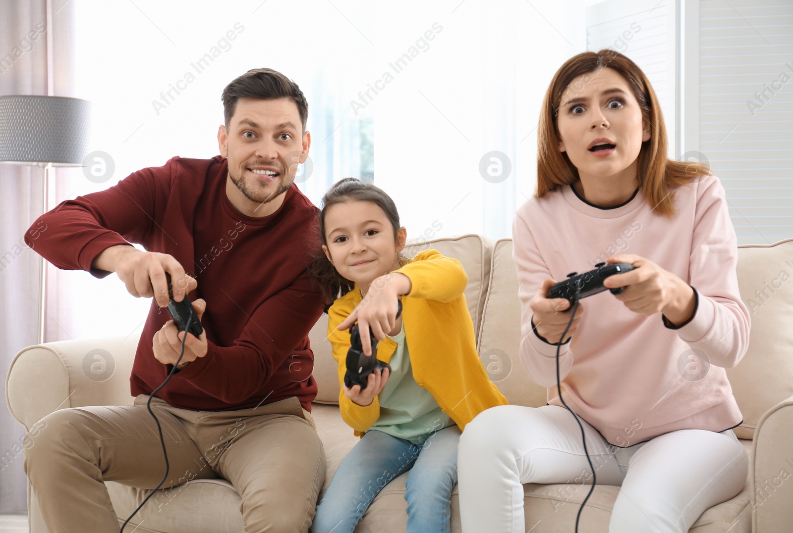 Photo of Happy family playing video games in living room