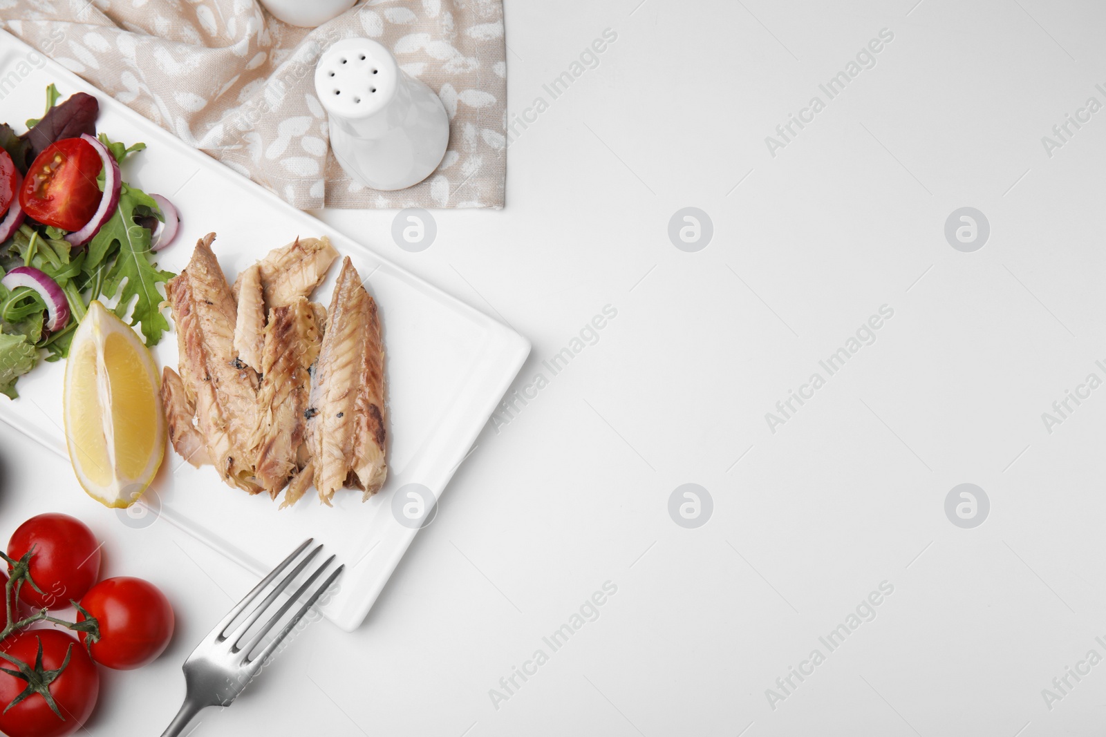 Photo of Delicious canned mackerel fillets served on white table, flat lay. Space for text