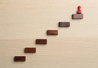 Photo of Red piece on top of stairs, flat lay. Career promotion concept