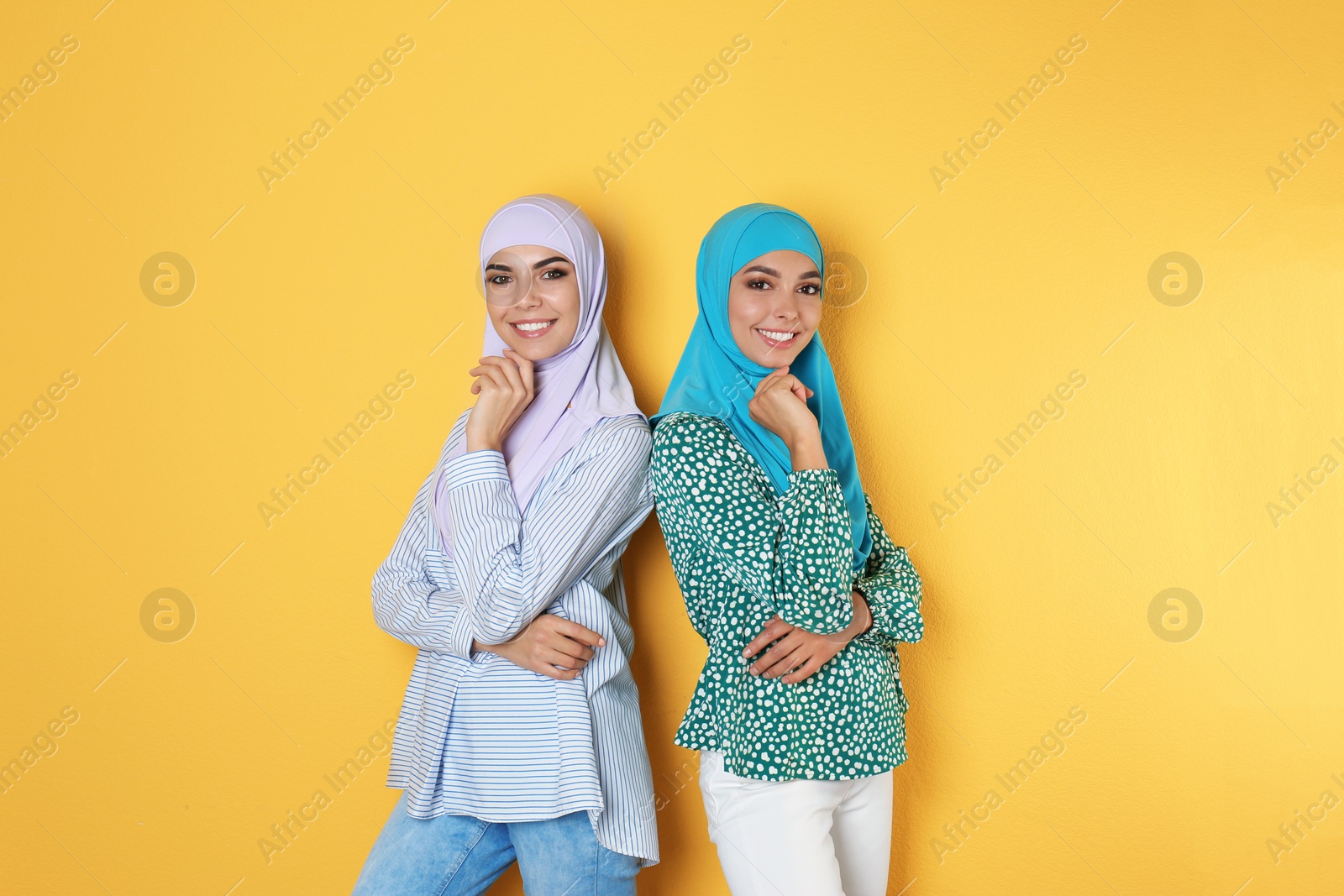 Photo of Portrait of young Muslim women in hijabs against color background