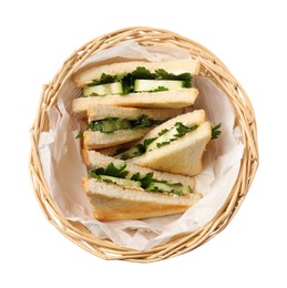 Photo of Tasty sandwiches with cucumber and parsley in wicker basket on white background, top view
