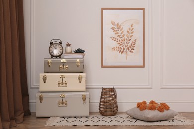 Many vintage storage trunks near white wall in room