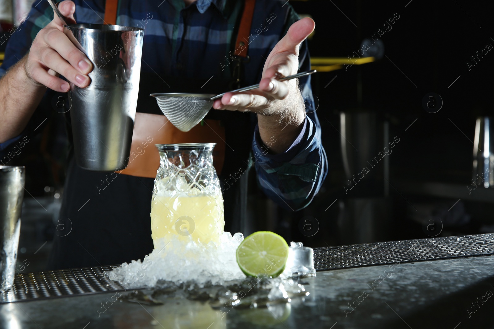 Photo of Barman making tropical cocktail at counter in pub, closeup. Space for text