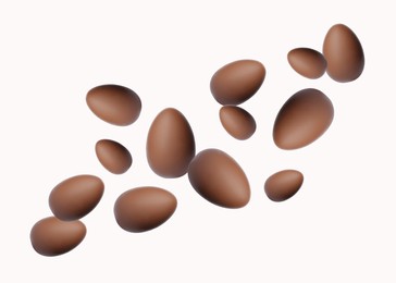 Image of Many chocolate eggs falling on white background