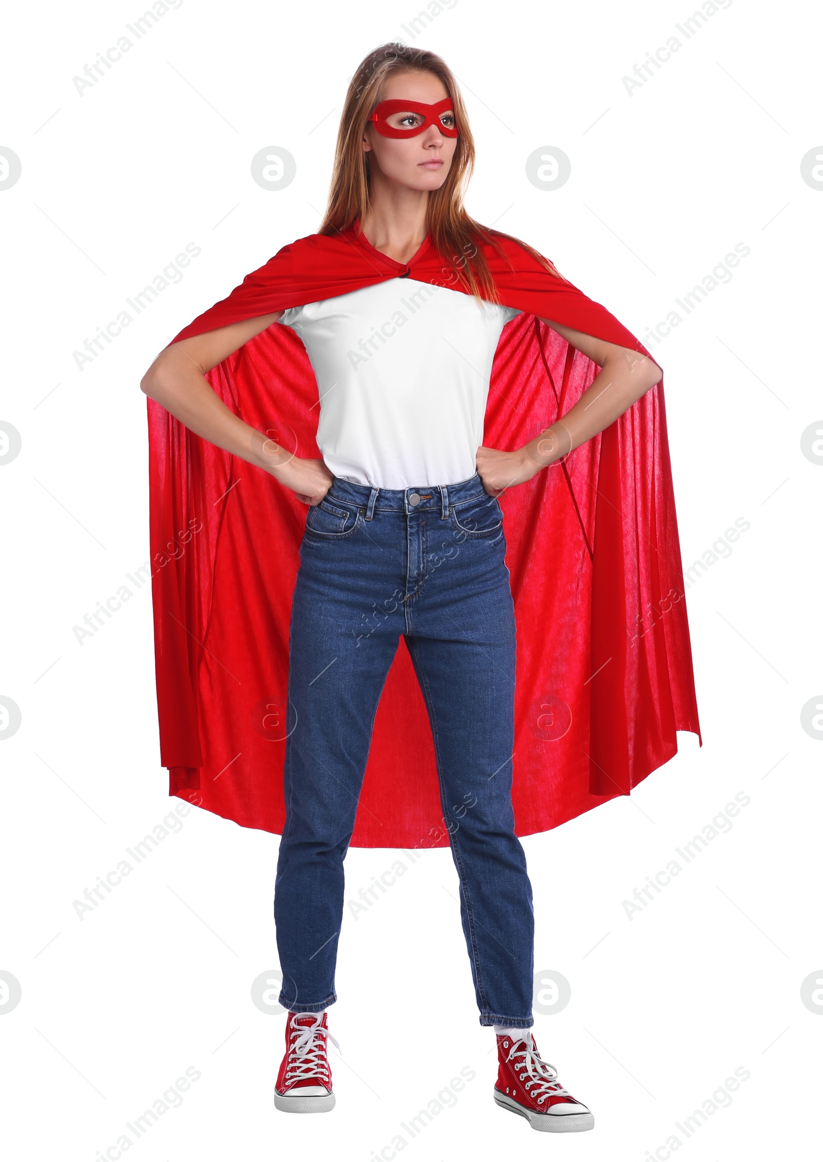 Photo of Confident woman wearing superhero cape and mask on white background