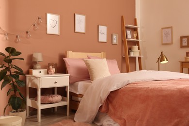 Photo of Teenage girl's bedroom interior with stylish furniture and beautiful decor elements