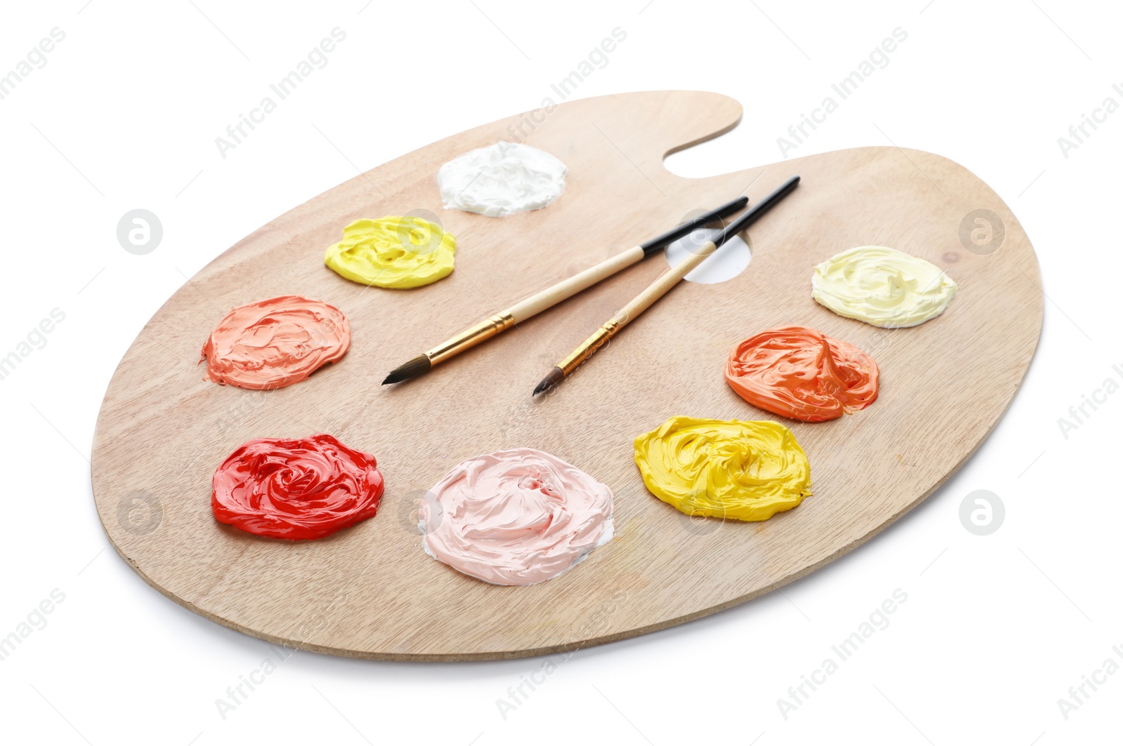 Photo of Palette with paints and brushes on white background