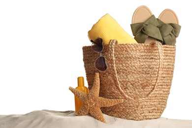 Photo of Bag with different beach objects on sand against white background