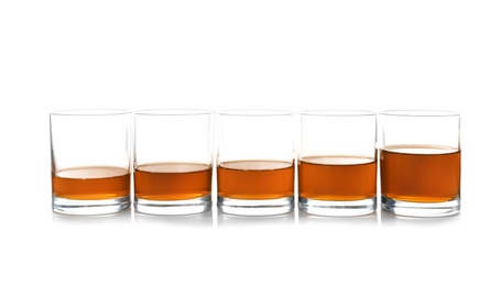 Glasses of scotch whiskey on white background, space for text