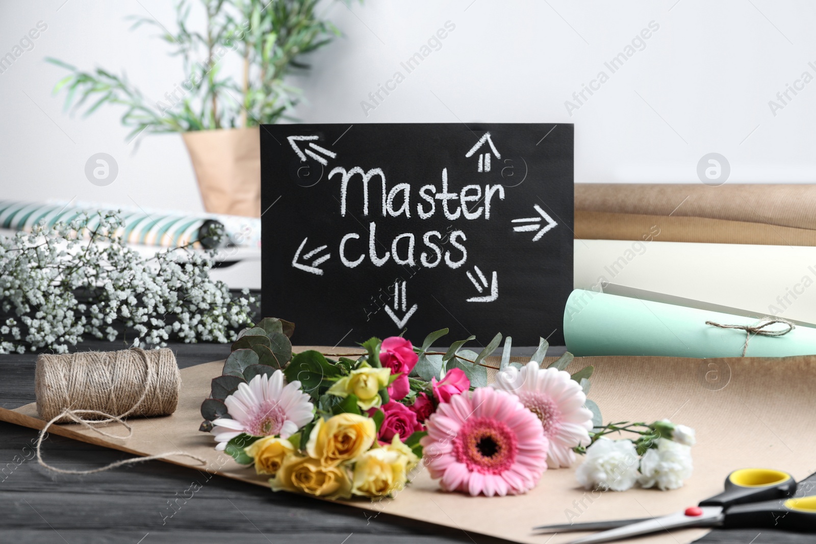 Photo of Card with words Master Class and supplies for flower arrangement on grey wooden table