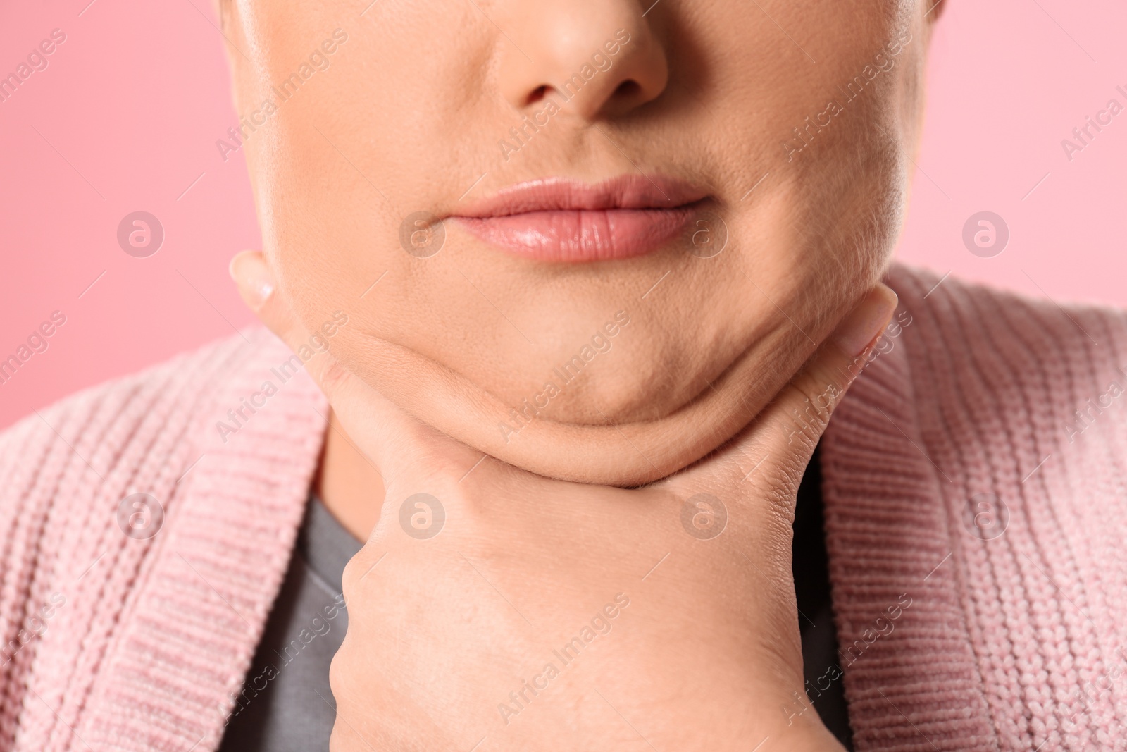 Photo of Woman with double chin on pink background, closeup