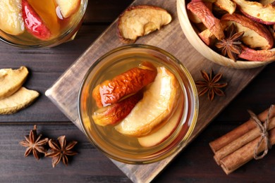 Delicious compote and ingredients on wooden table, flat lay