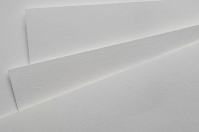 Photo of Blank watercolor paper sheets on white background, top view