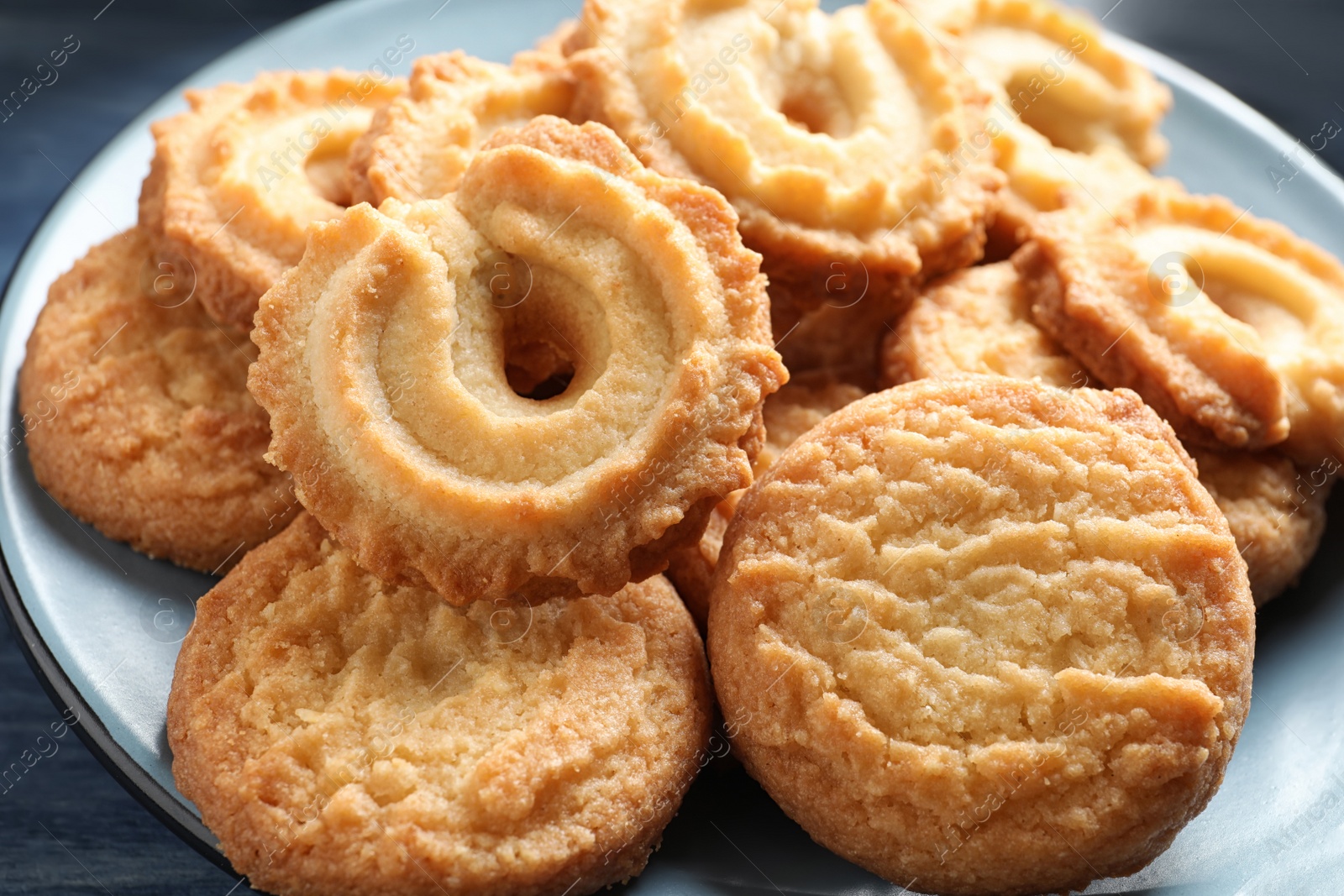 Photo of Plate with Danish butter cookies on table, closeup