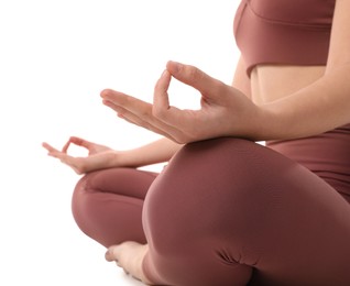 Woman in sportswear meditating on white background, closeup