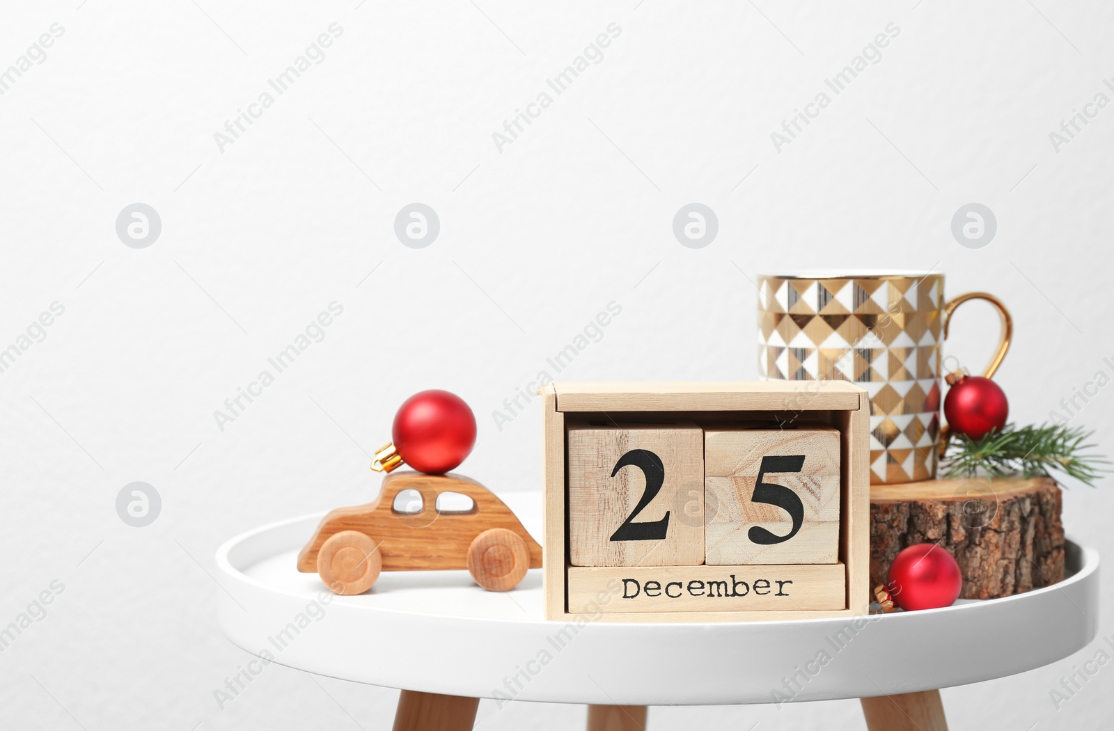 Photo of Wooden block calendar and festive decor on table. Christmas countdown