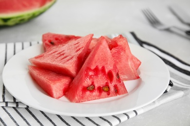 Photo of Yummy watermelon slices on white table, closeup